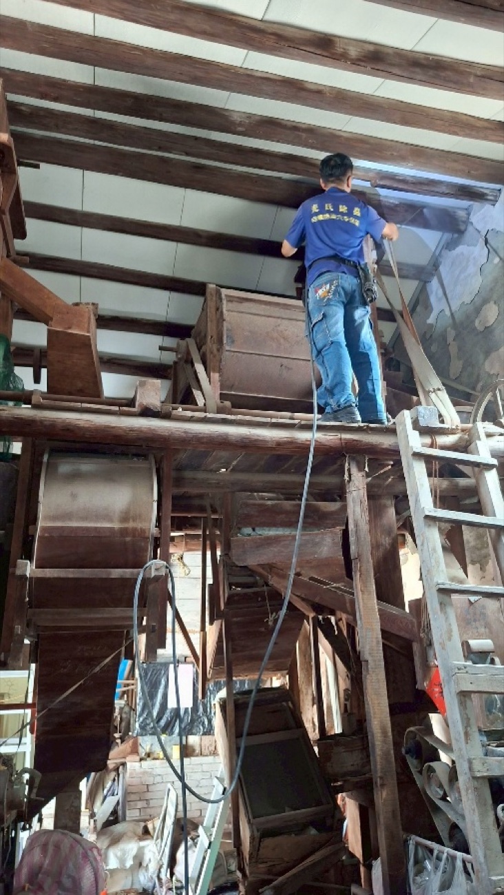 站上鋁梯處理平房的室內木作屋架