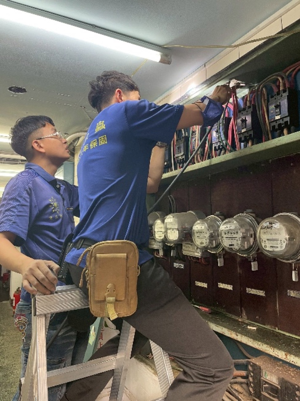 兩位師傅處理電錶箱與大門區域